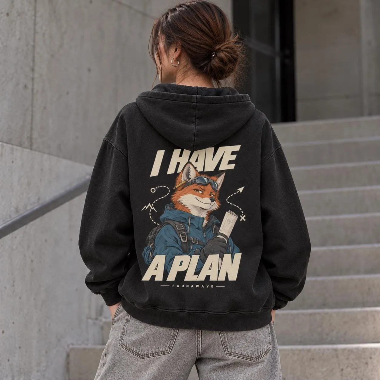 Woman wearing Faded Black oversized fox hoodie with I Have a Plan back print (illustrative mockup)