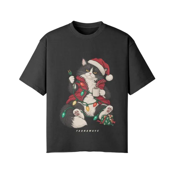 Grumpy Christmas cat graphic T-shirt, tuxedo cat in a Santa hat tangled in festive lights, Faded Black oversized faded tee, front print, flat lay